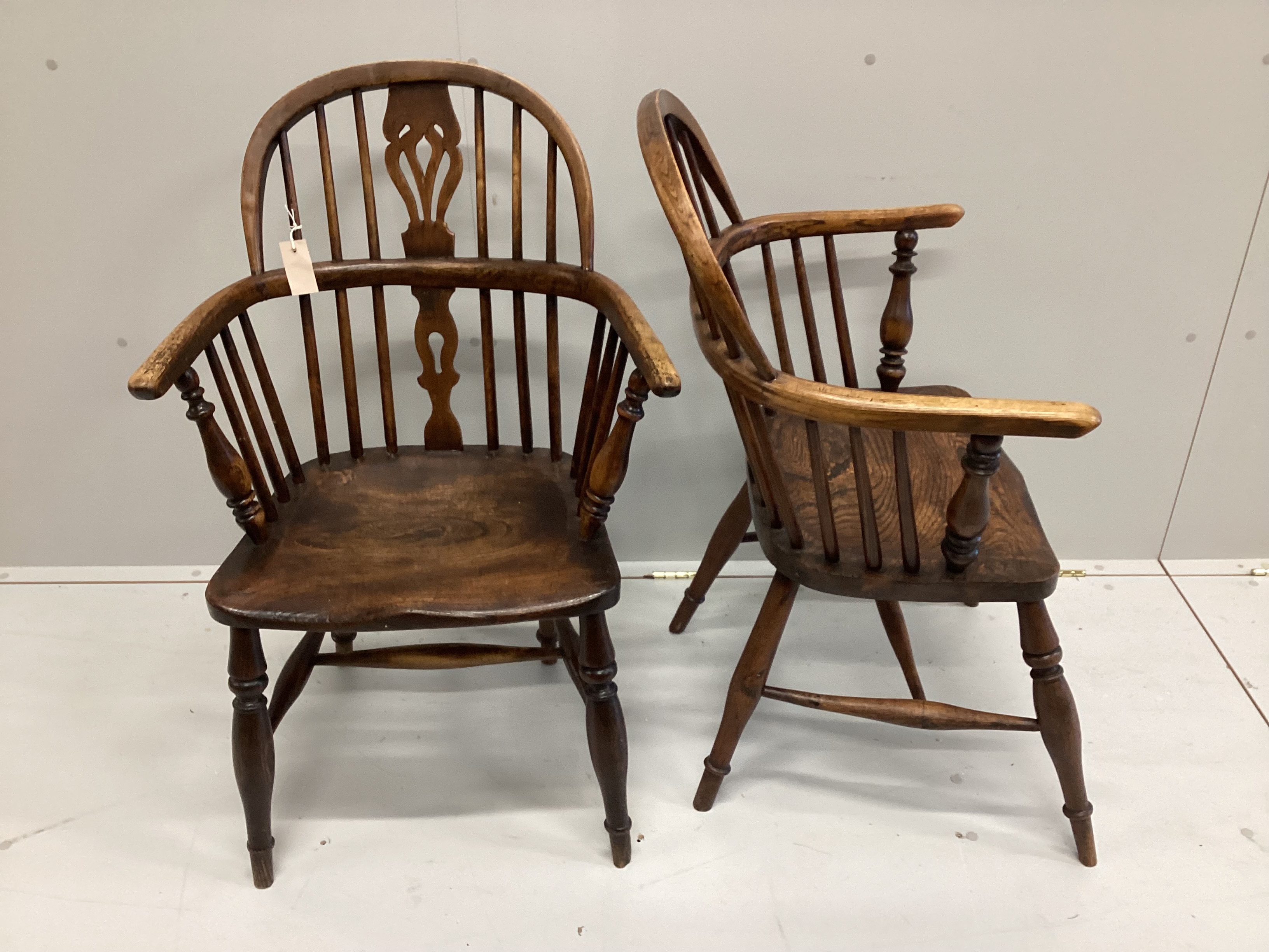 A near pair of 19th century ash and elm Windsor elbow chairs, width 59cm, depth 37cm, height 94cm